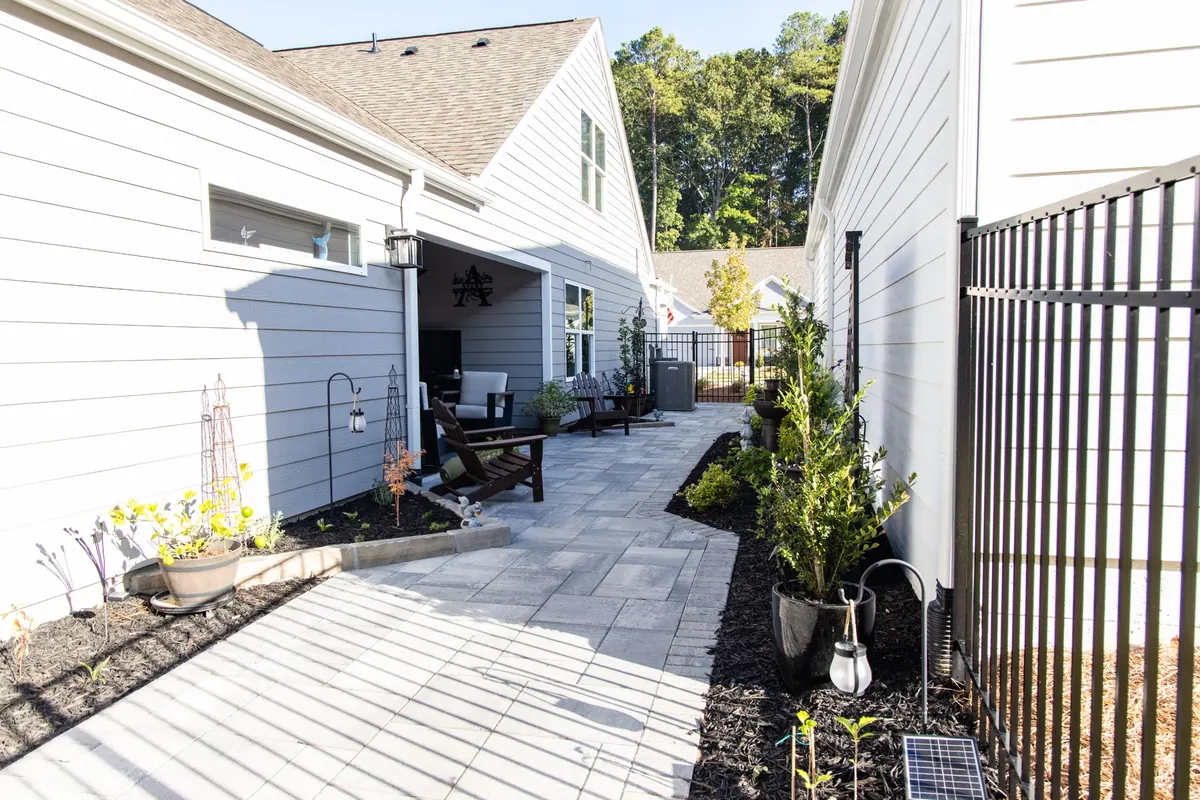 Paver passage and plantings along the house at the Avery project