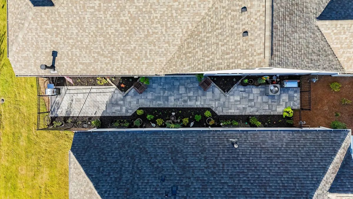 Drone view straight down the finished Avery side-passage between the two rooflines
