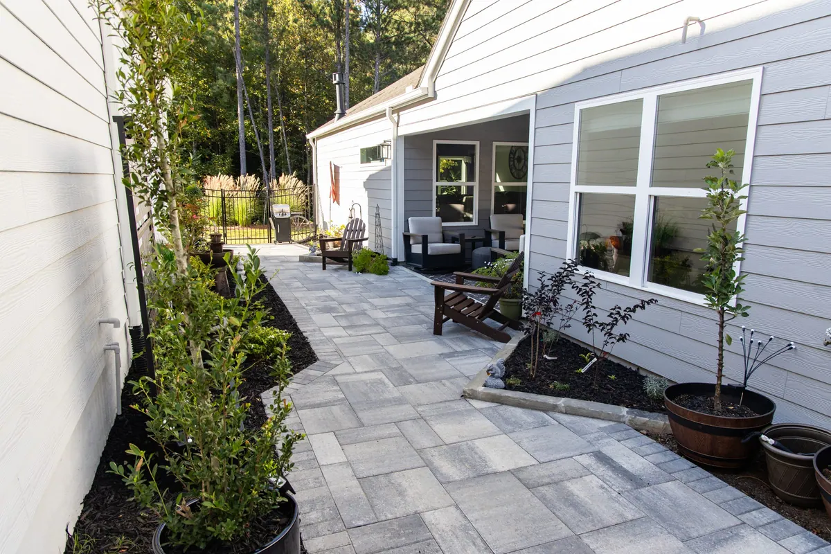 The paver passage opening onto the back porch seating area at the Avery project