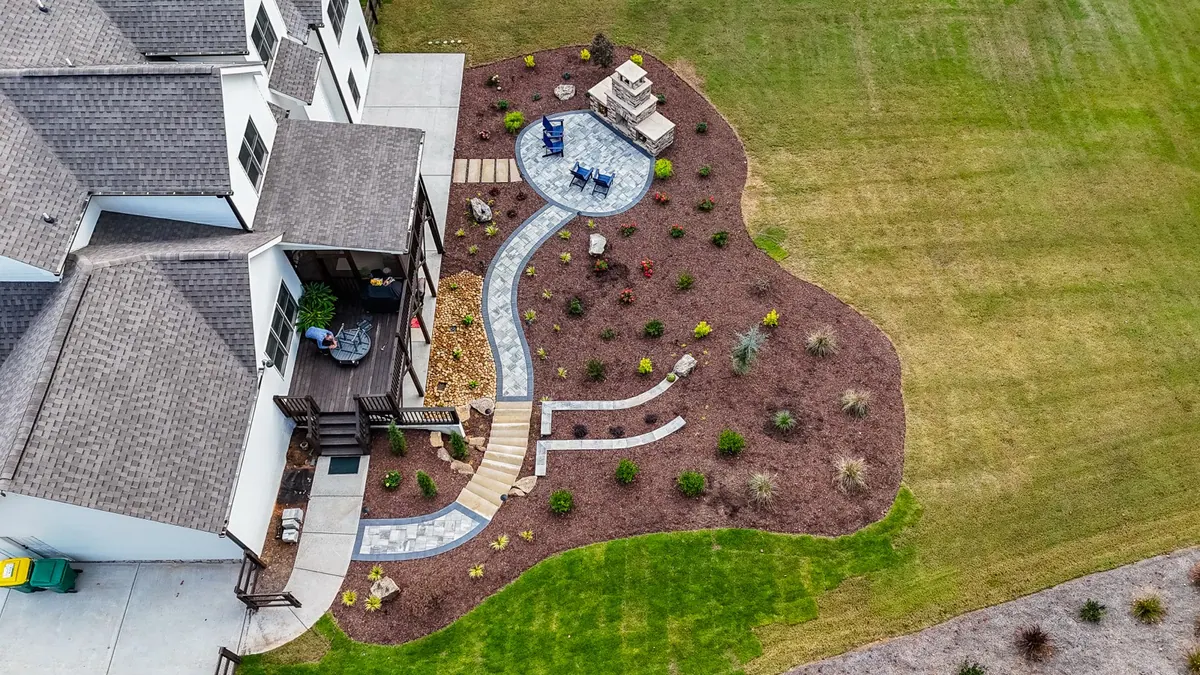 Aerial view of the Ball Ground fireplace patio and curved path beside the house
