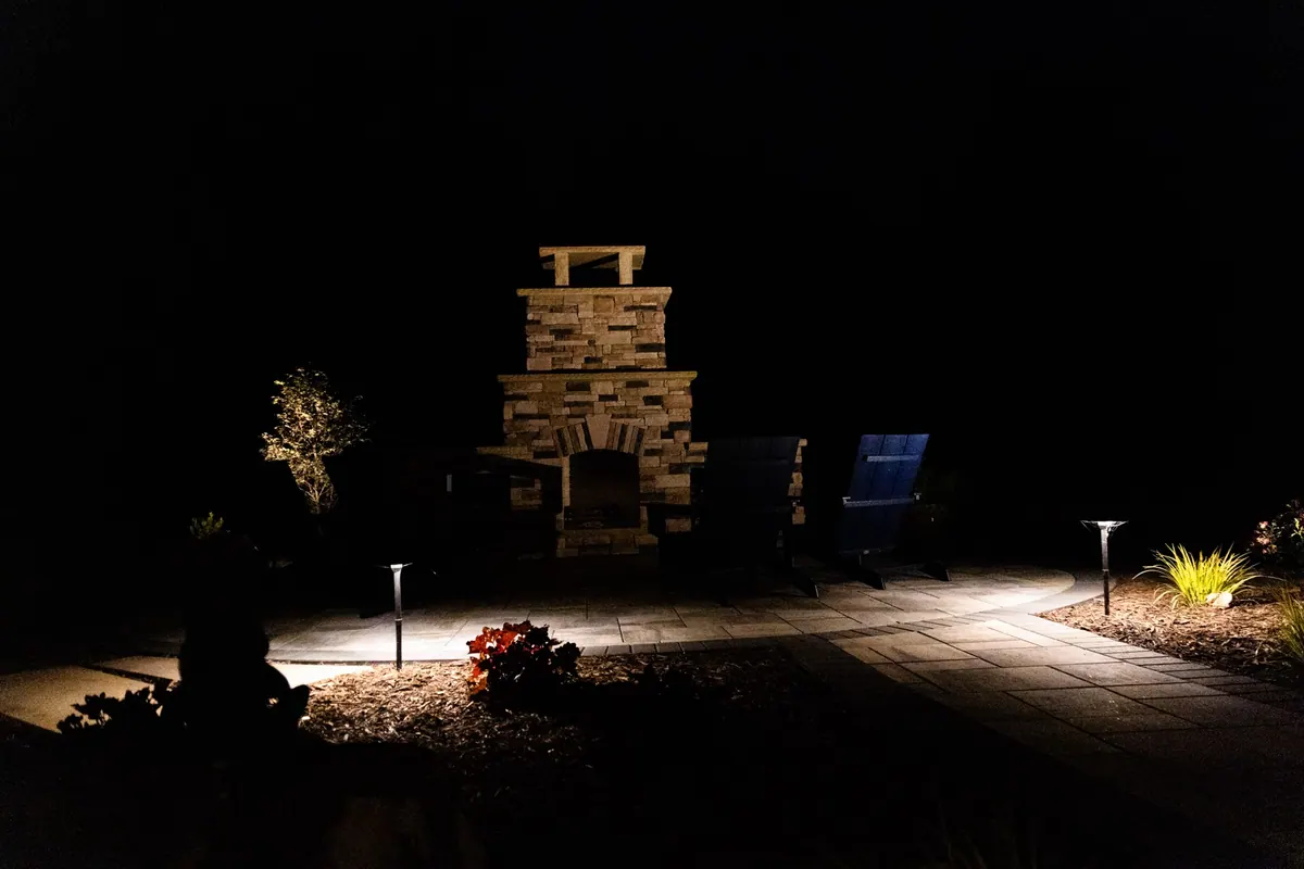 The Ball Ground stone fireplace lit up at night