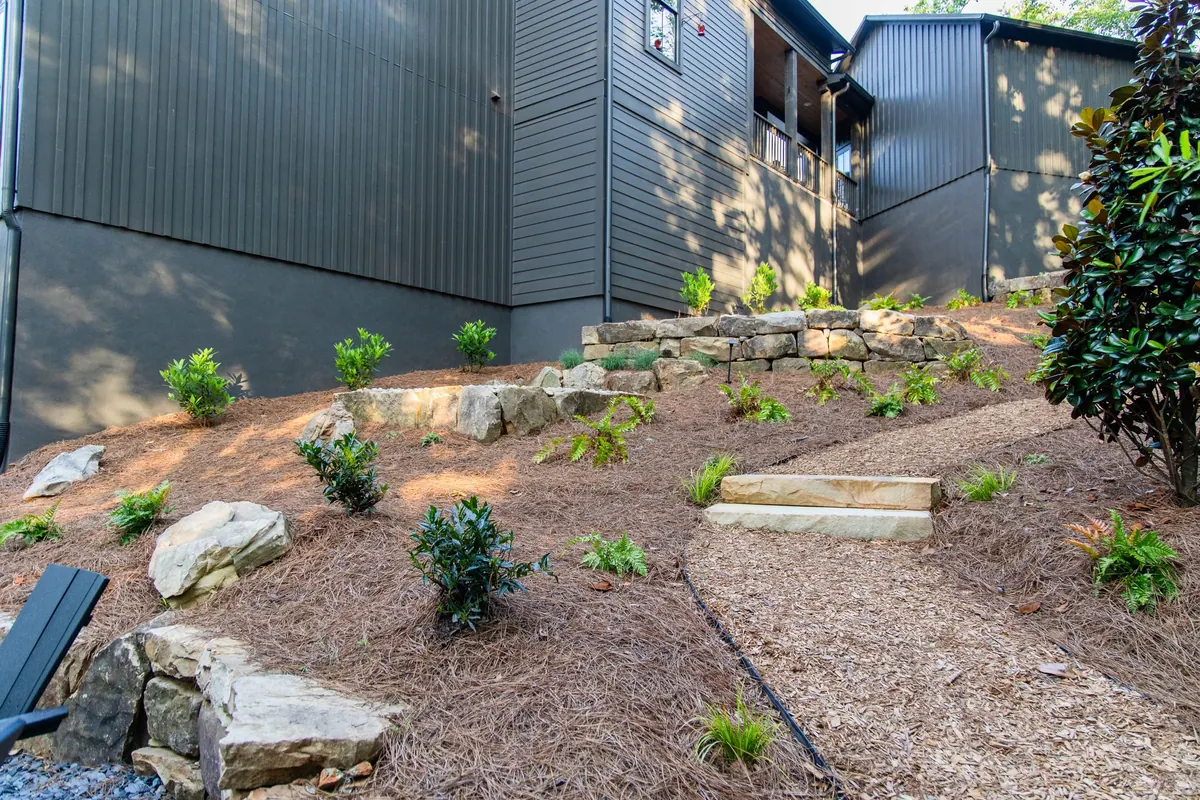 Boulder retaining walls and new planting holding the regraded hillside at the Blueberry Ridge project
