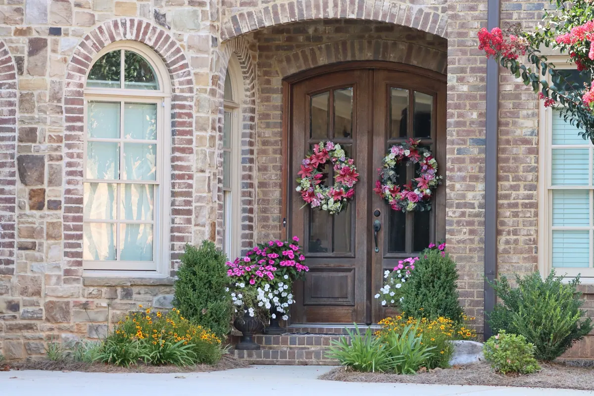 Brick front entry with fresh plantings and a clean walkway