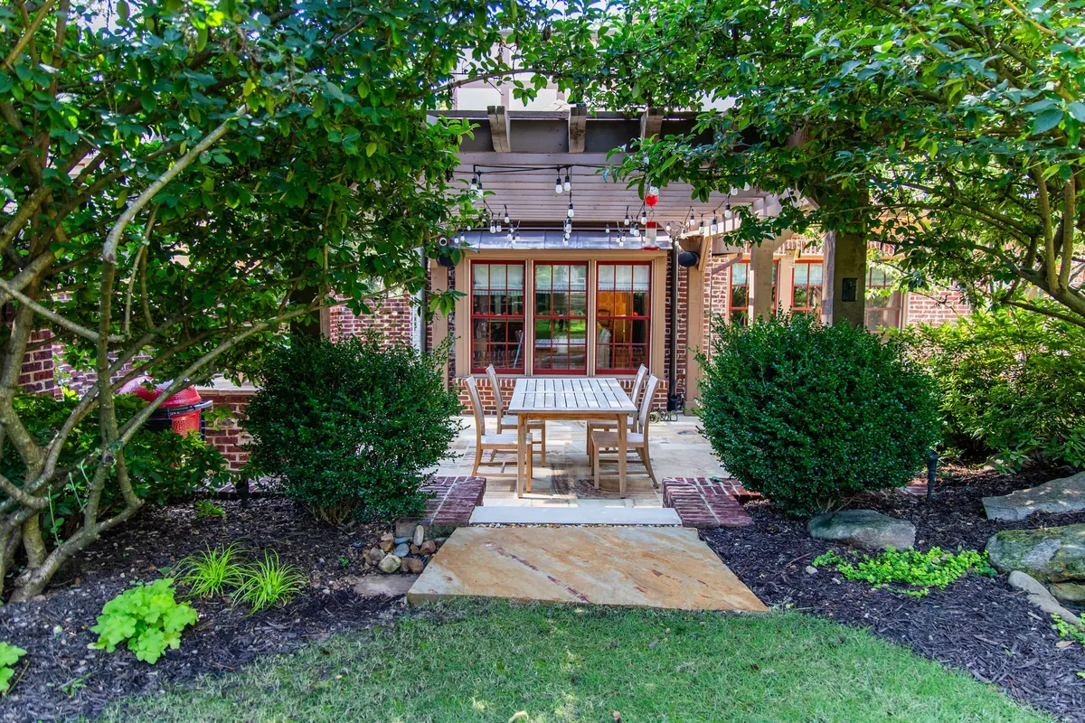Stone terrace and mature garden borders at the Eulalia Road garden in Atlanta