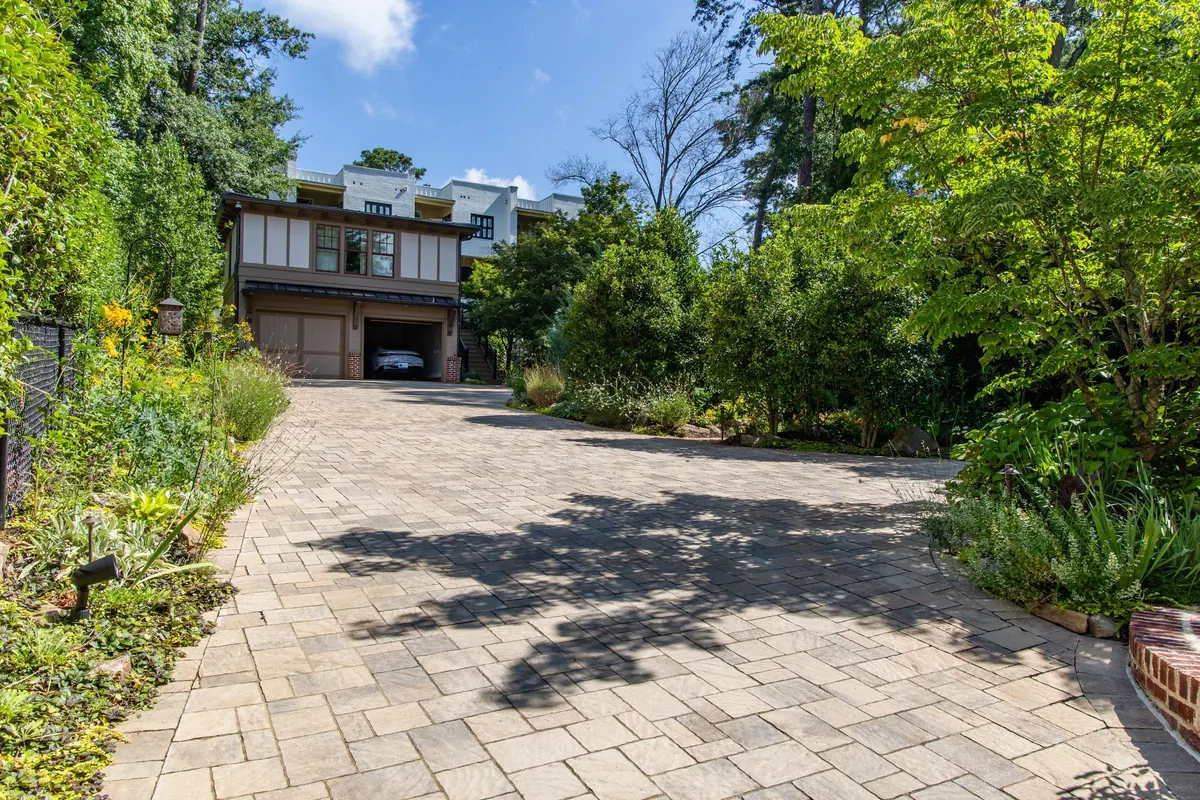 Paver auto court and drive framed by layered planting at the Eulalia Road garden