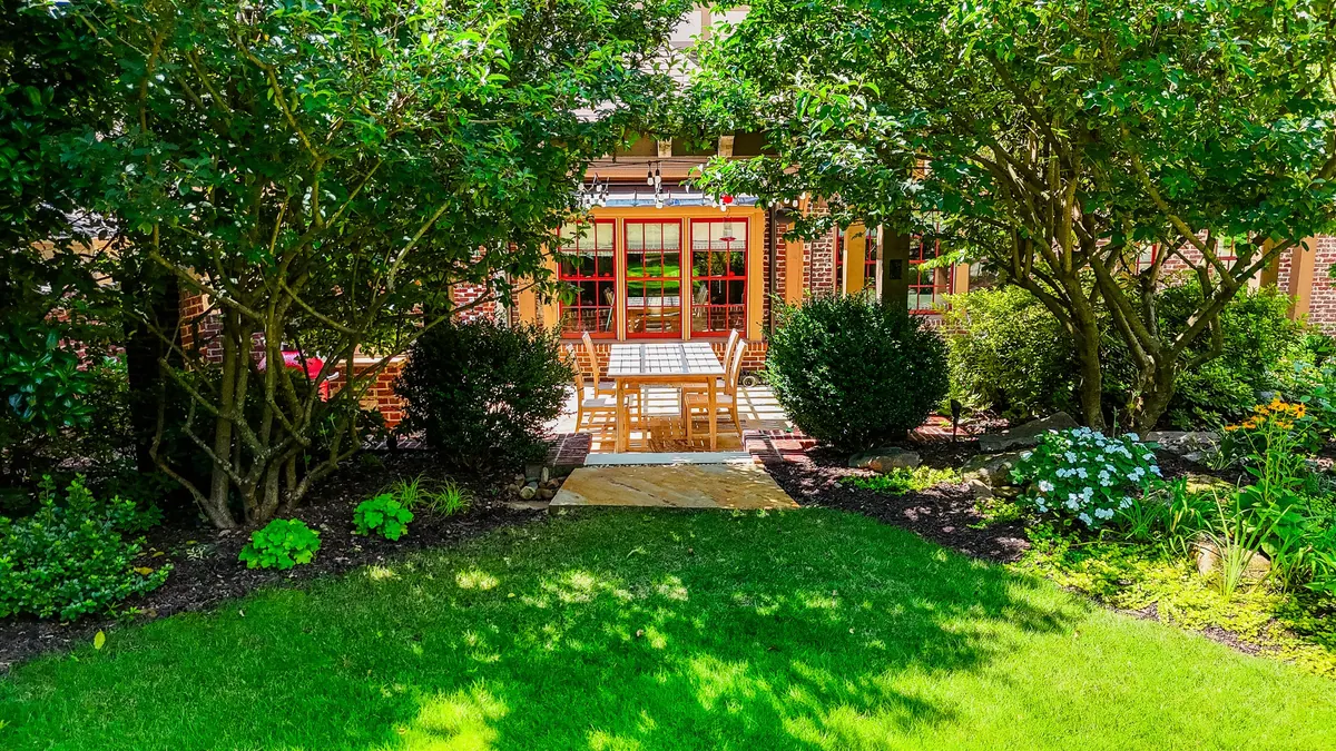 Lawn and mature planting beds leading to the garden pavilion at Eulalia Road