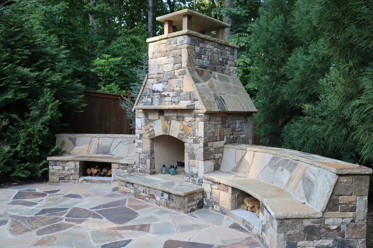 Custom stone fireplace with curved built-in benches on a GreenTree build
