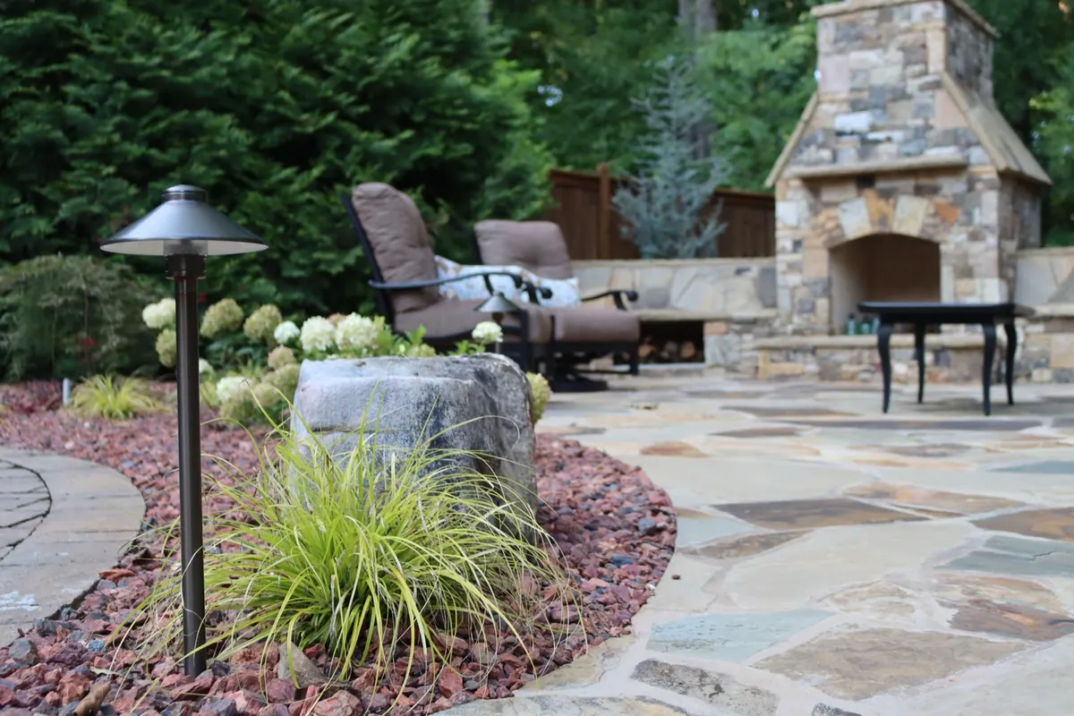 Flagstone patio with lounge seating and an outdoor fireplace