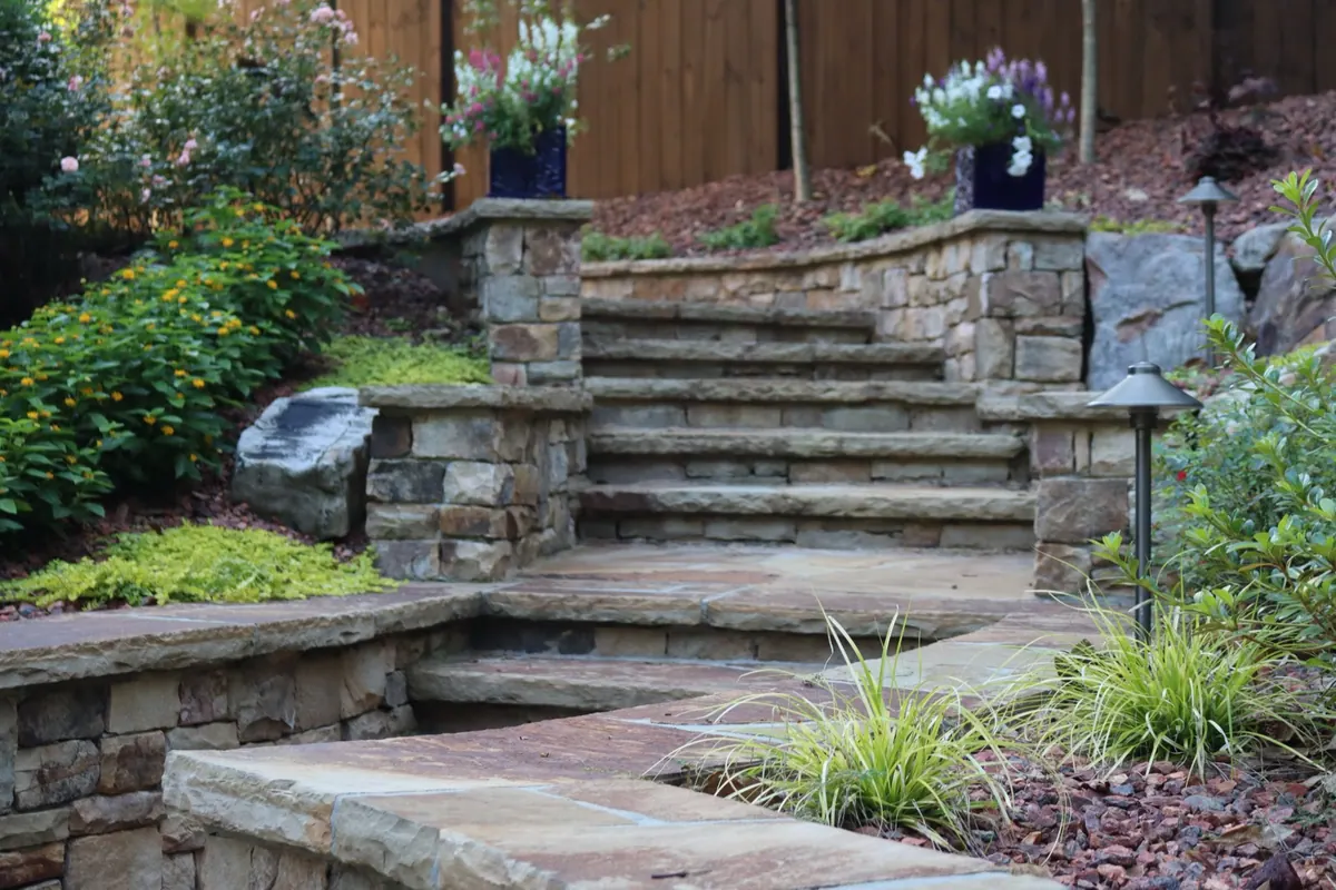 Stone steps and retaining walls with mature plantings