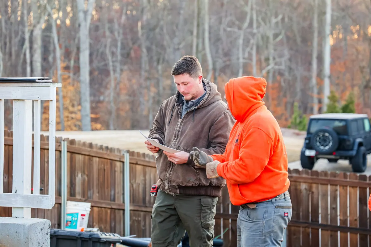 Jay reviewing the project plan with the GreenTree crew on site.
