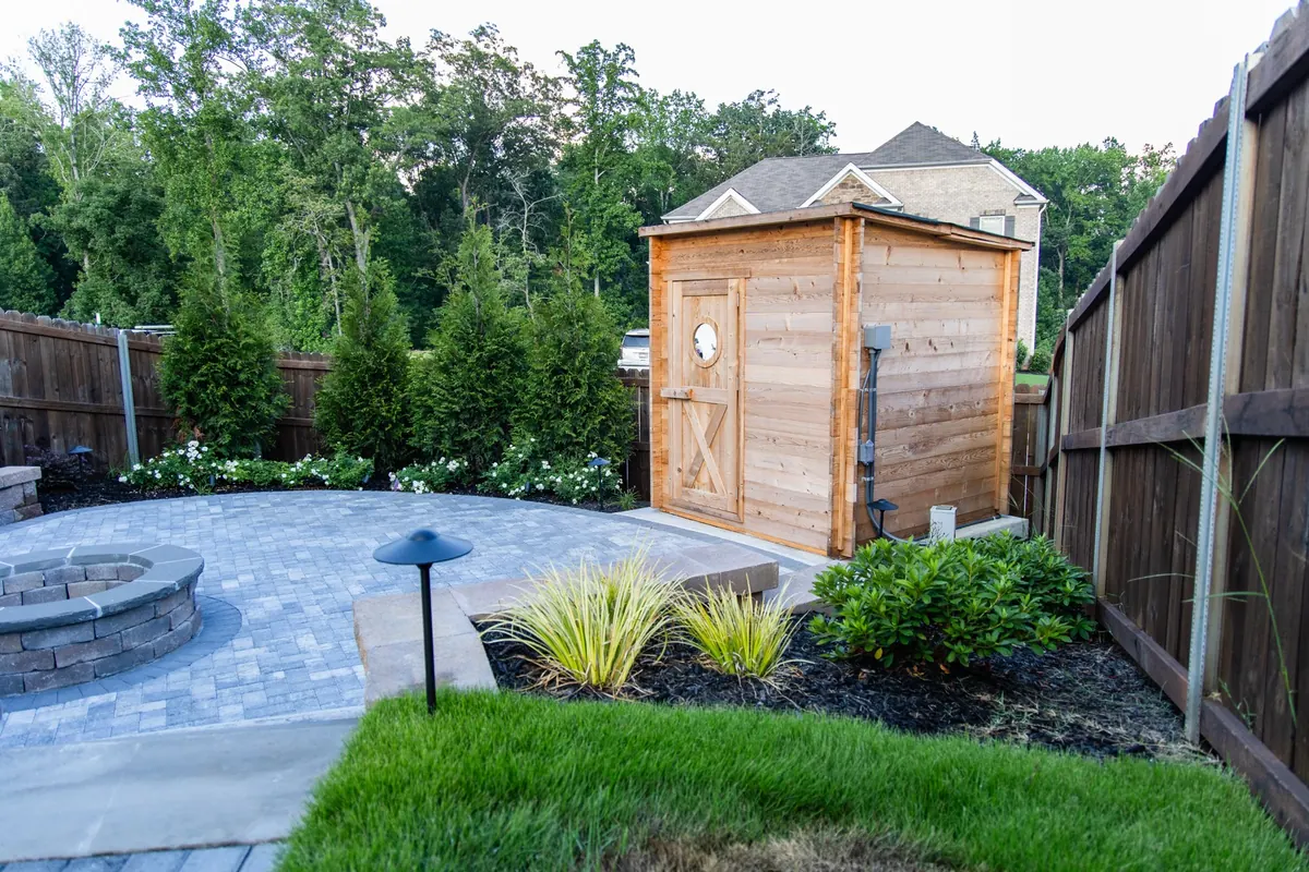 Paver patio, cedar sauna, and new planting on a complete backyard build