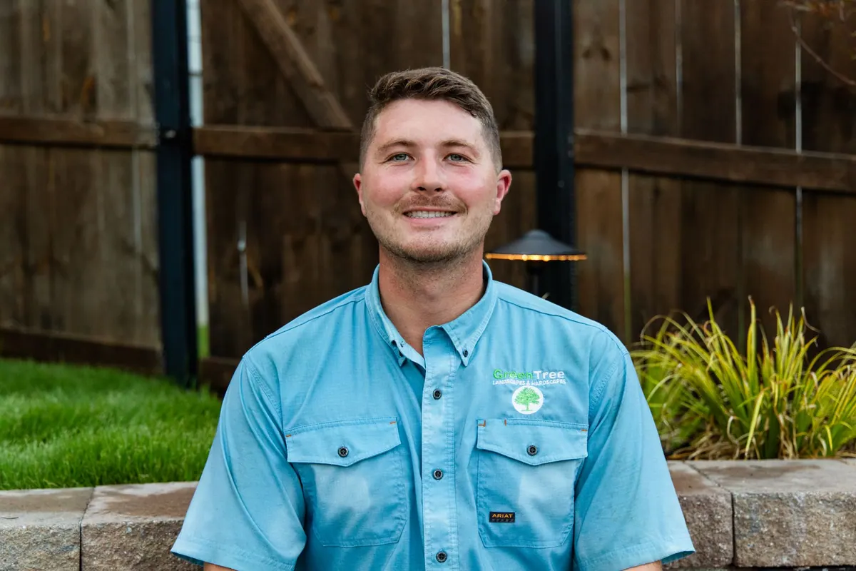 Jay Wilkinson, owner of GreenTree Landscapes, in a GreenTree work shirt in a finished backyard